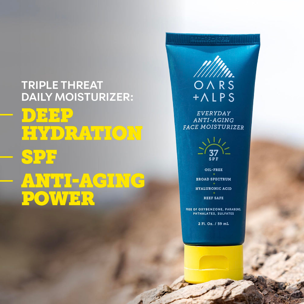 Oars + Alps 2oz tube held in hand to show compact travel-friendly size and convenience
