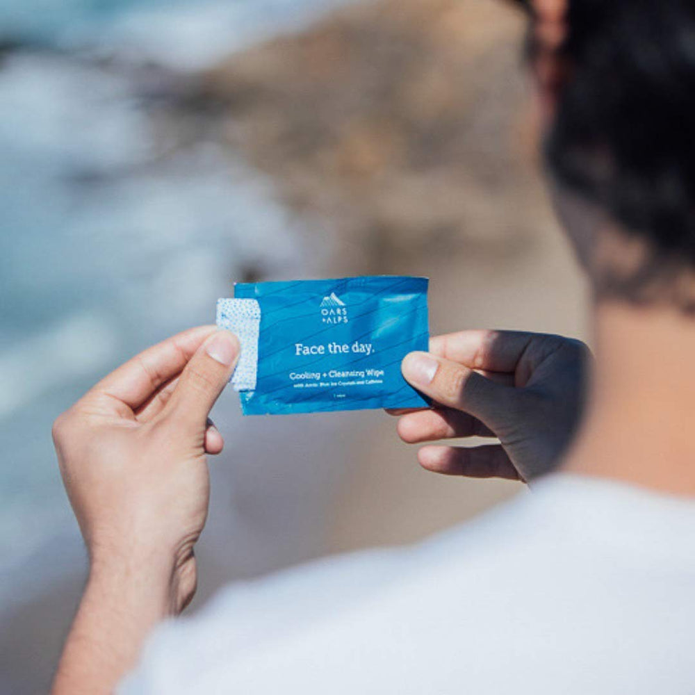 Oars + Alps open pack exposing moist wipe that exfoliates and cools skin