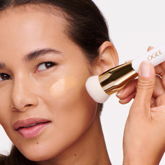 Ogee brush in use with tinted serum for even coverage and natural finish