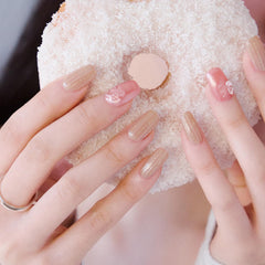 ohora applied on fingernail demonstrating rosy bow gold glitter accent