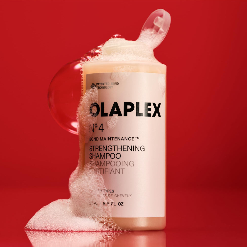 Olaplex No.4 bottle held in hand to show 100 mL size and travel convenience