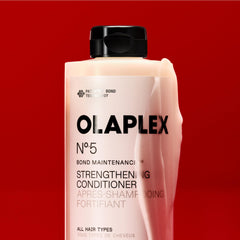 Applying Olaplex No.5 to mid‑lengths and ends to show repair and hydration benefit