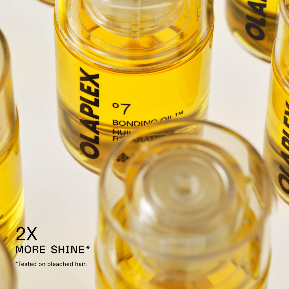 Olaplex No.7 ingredient vials illustrating coconut-derived emollient and conditioning benefits