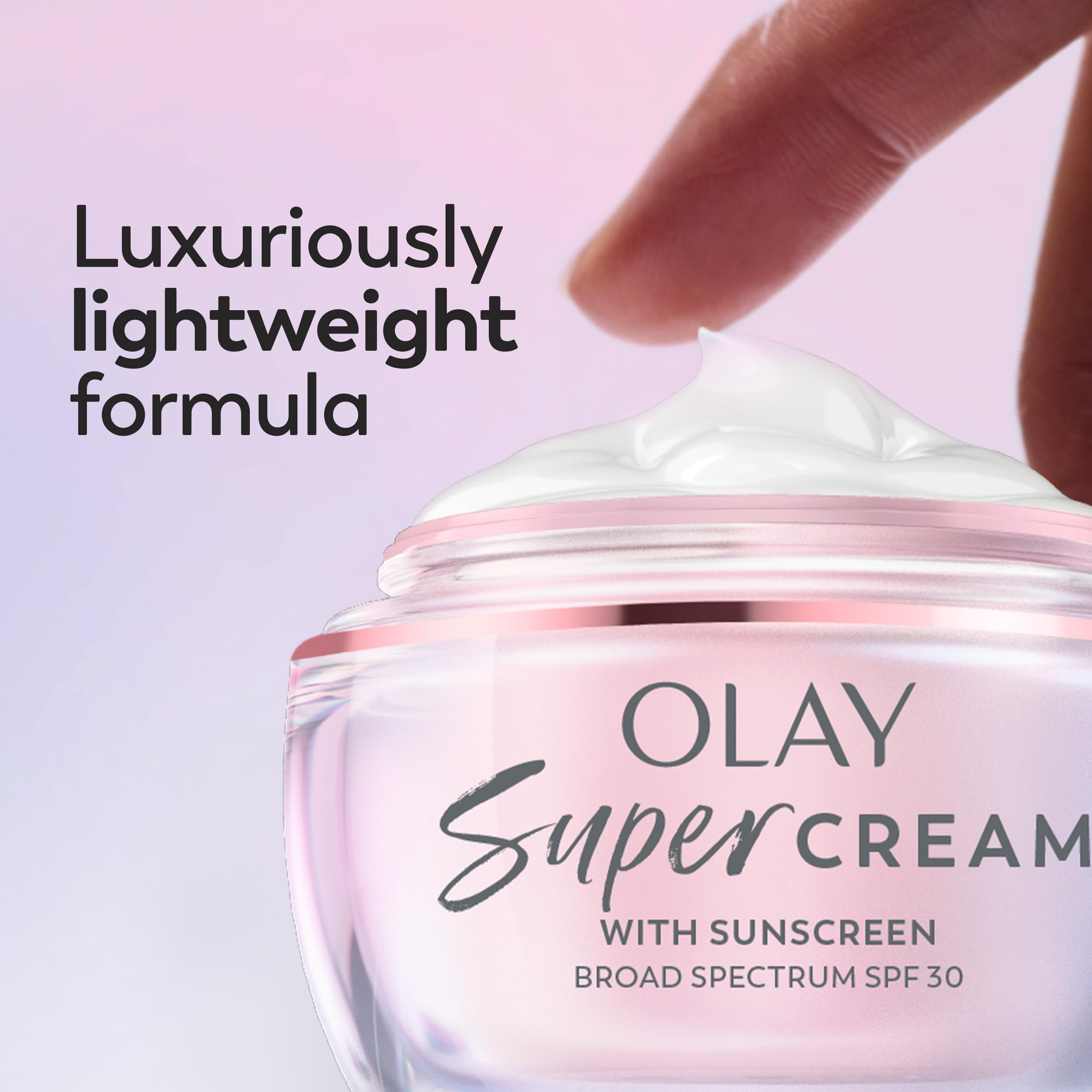 Olay Super Cream 15 mL tube next to wallet to show travel-friendly size