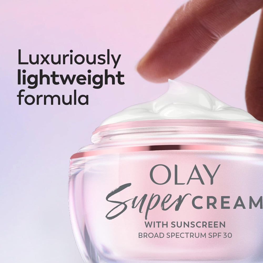 Olay Super Cream 15 mL tube next to wallet to show travel-friendly size