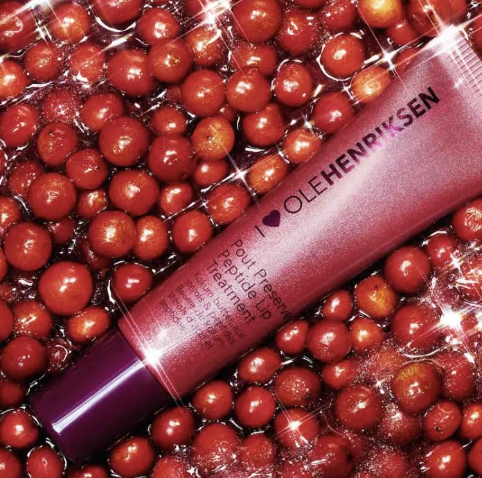 OLEHENRIKSEN lifestyle shot applying treatment on lips for instant moisture and subtle glimmer