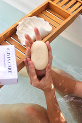 Olivia Care bar producing creamy lather in a hand, demonstrating gentle hydration