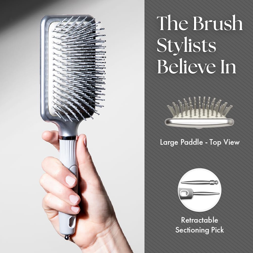 Olivia Garden paddle brush held in hand to show scale and ergonomic grip for comfortable styling
