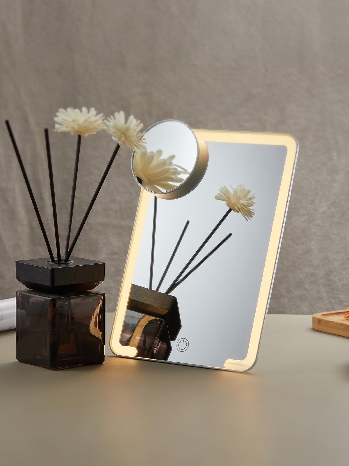OMIRO mirror on a vanity styled with cosmetics for lifestyle-ready organization benefit