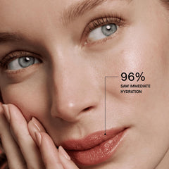 Model applying OneSkin OS-01 lip balm demonstrating sun protection and natural finish