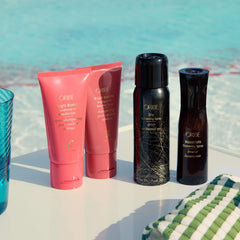 Oribe Bright Blonde Conditioner being applied to blonde hair mid-lengths demonstrating detangling and toning benefit