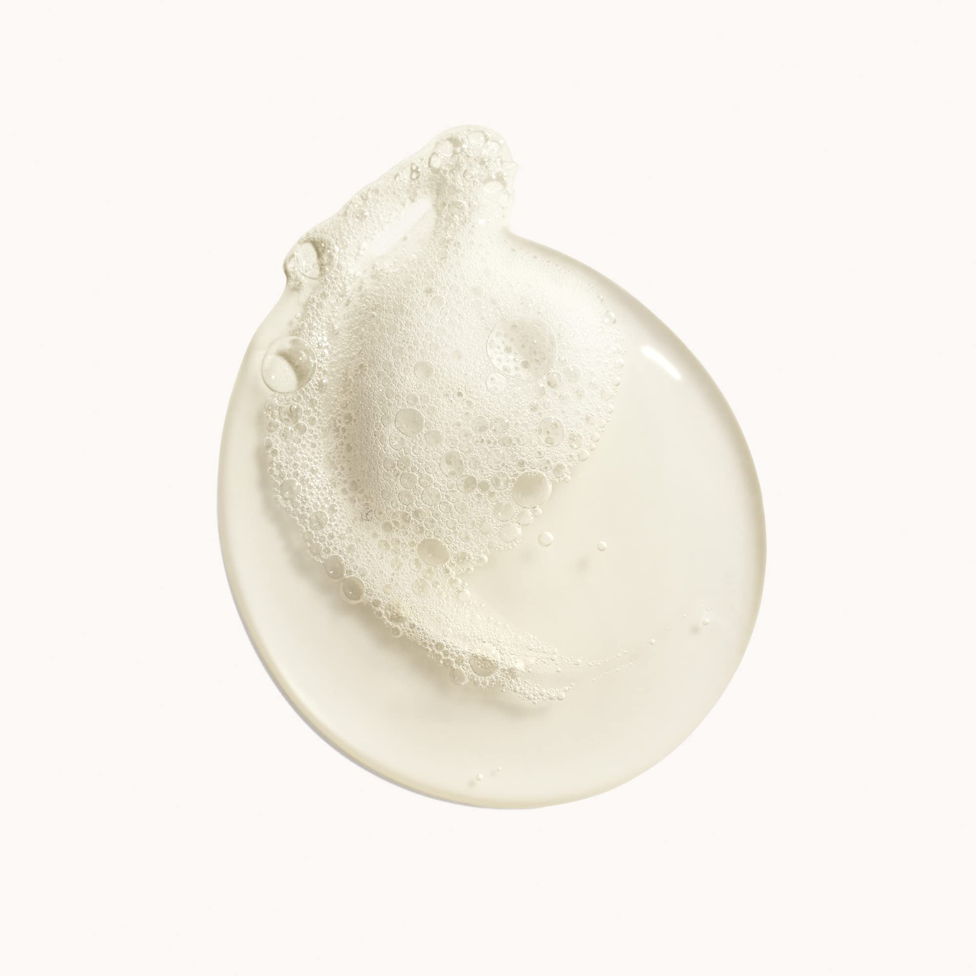 ORIBE close-up of pearlescent body wash texture highlighting creamy foaming benefit