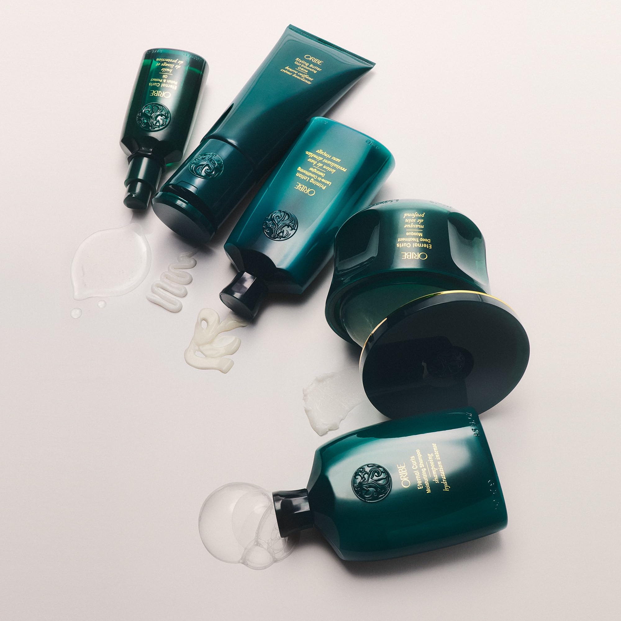 Oribe curl gel styled on bathroom shelf in luxury setting for salon-quality routine