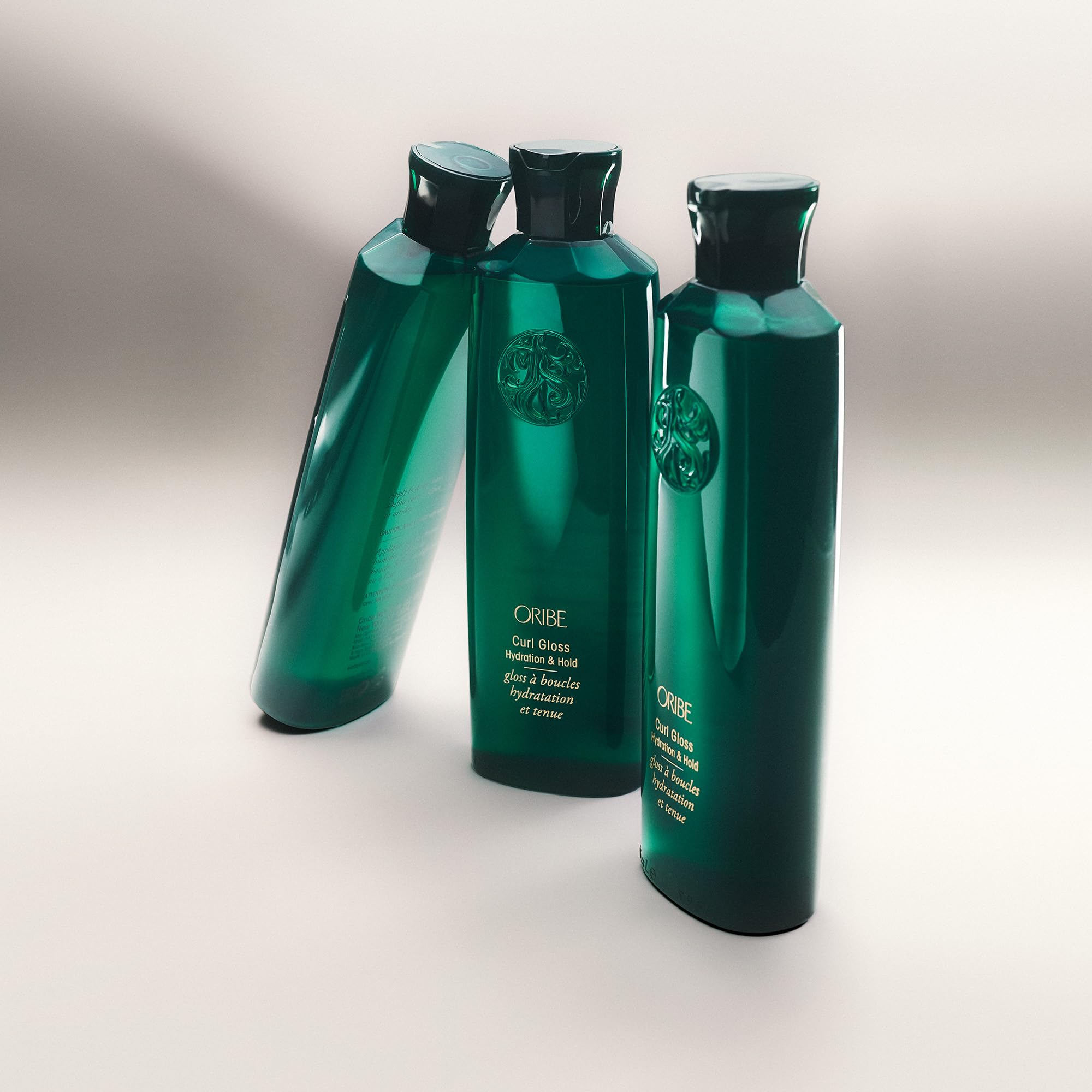 Oribe Curl Gloss applied to damp curls demonstrating frizz control