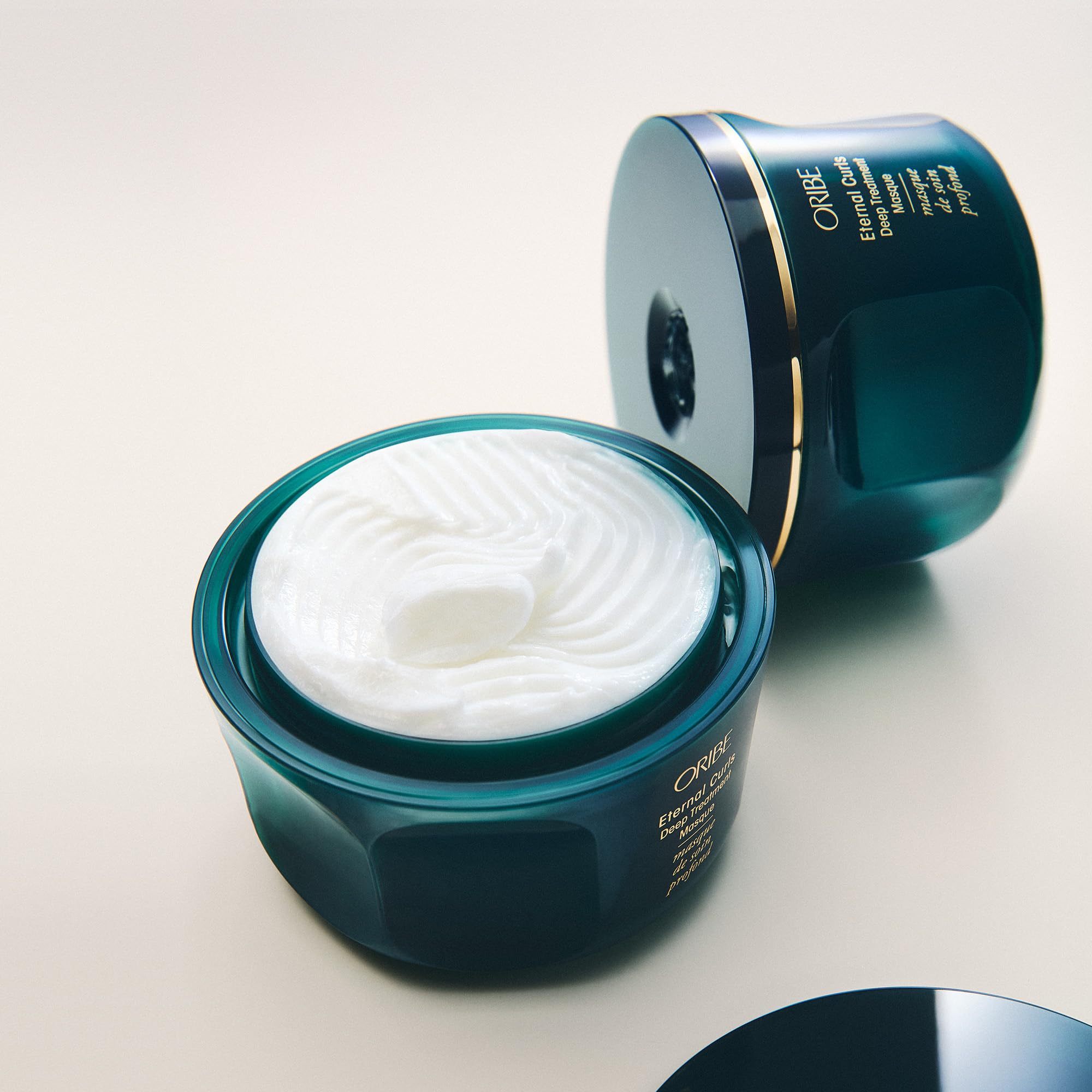ORIBE before and after hair panel showing smoother, less frizzy curls
