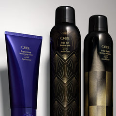ORIBE Free Styler being applied to styled hair on model for touchable, brushable finish