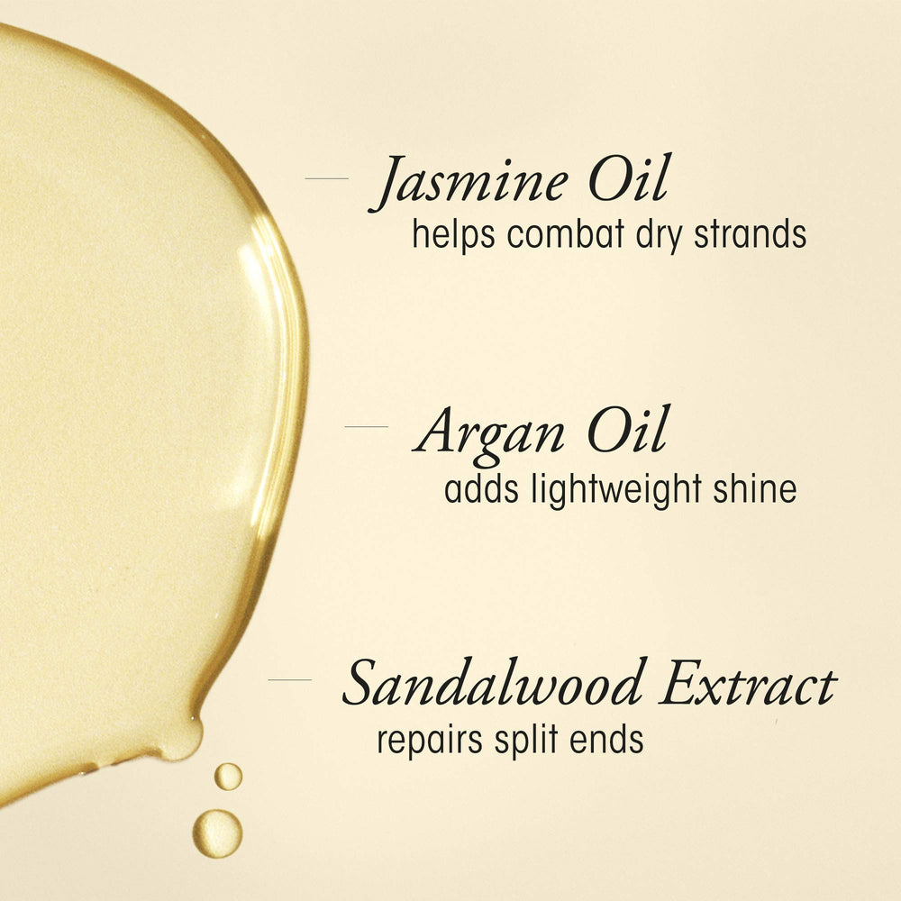 Oribe oil drop on fingers highlighting silky texture and quick absorption benefit