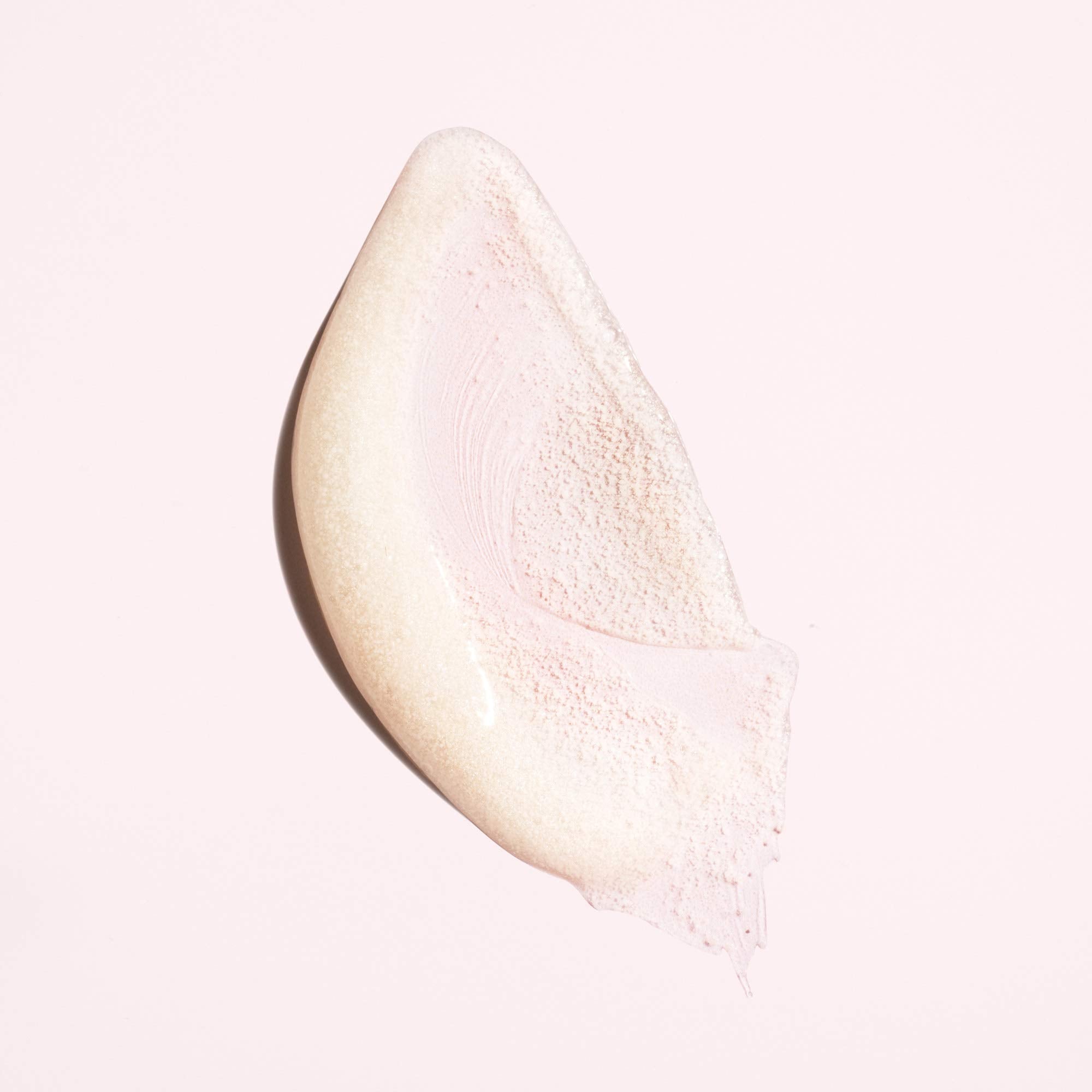 Oribe in-use scalp massage with hands working scrub into roots, showing clarifying benefit