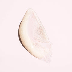 Oribe in-use scalp massage with hands working scrub into roots, showing clarifying benefit