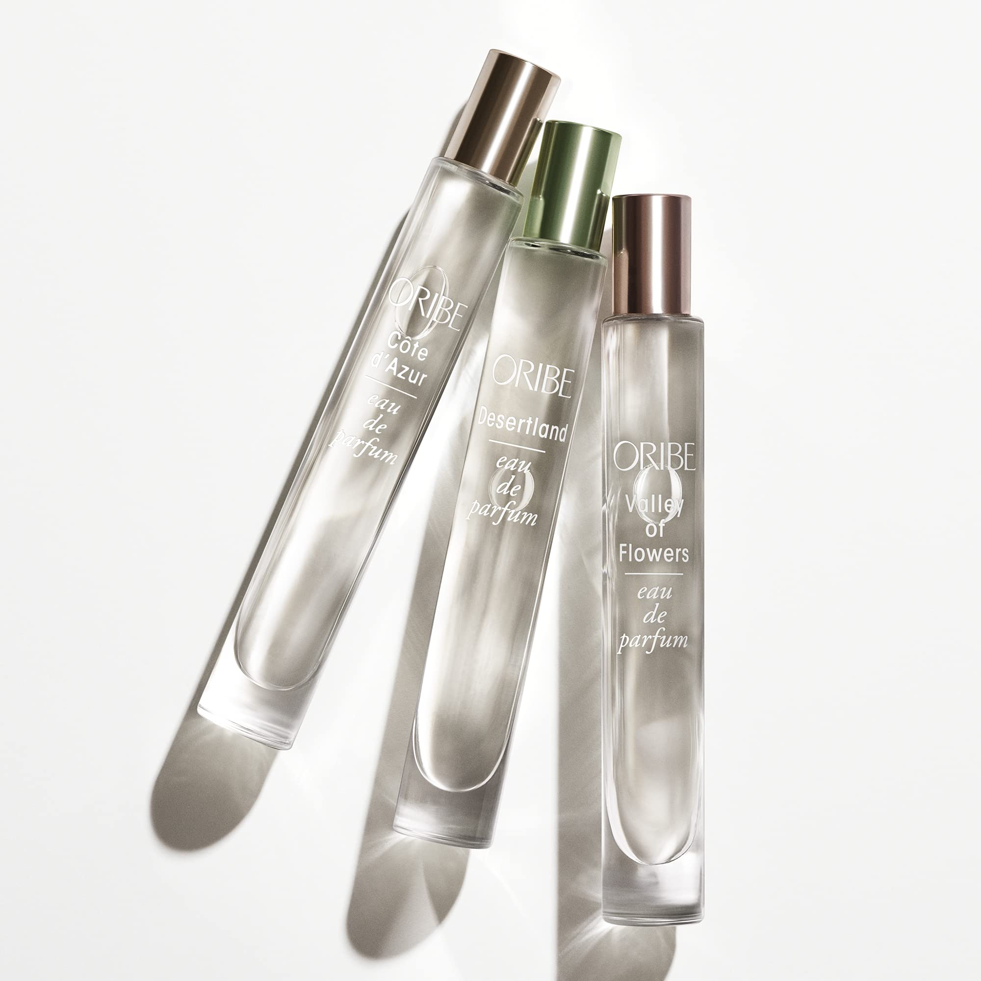 ORIBE bottle on terrace at sunset evoking Mediterranean warmth and wearable elegance