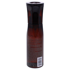 Oribe Maximista being sprayed on damp hair to add lift and heat protection