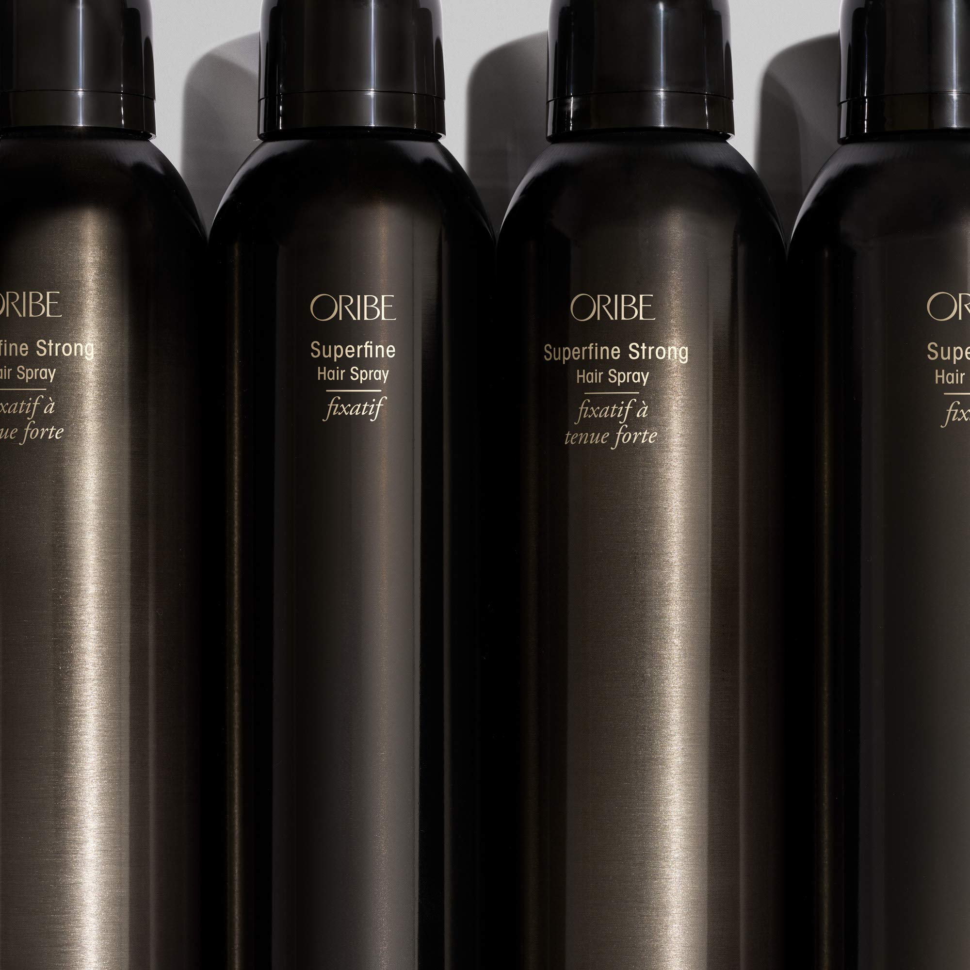 Oribe Superfine held in hand for size comparison and travel-friendly benefit