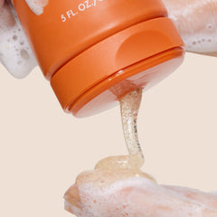 Origins GinZing dispensing foam from pump demonstrating easy application and rinseability