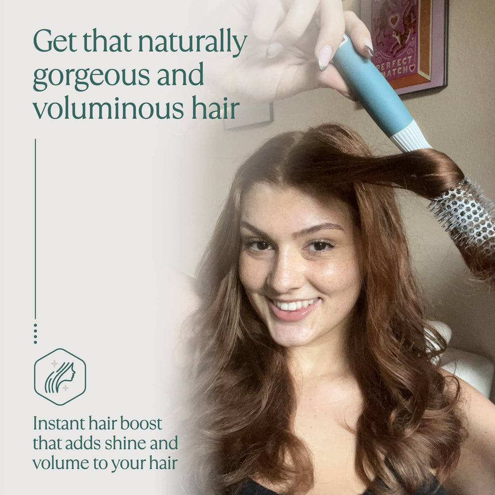 Osensia brush held in hand showing compact size for precise styling