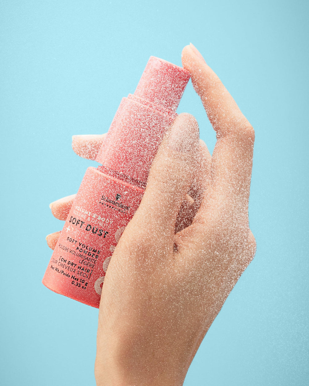 OSiS+ soft dust scale comparison in hand indicating travel-friendly size