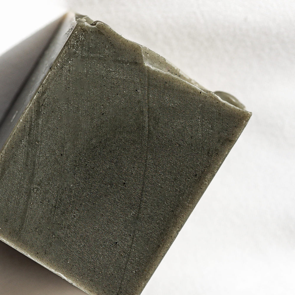 Osmia hand lathering bar into white foam for creamy cleansing without dryness benefit