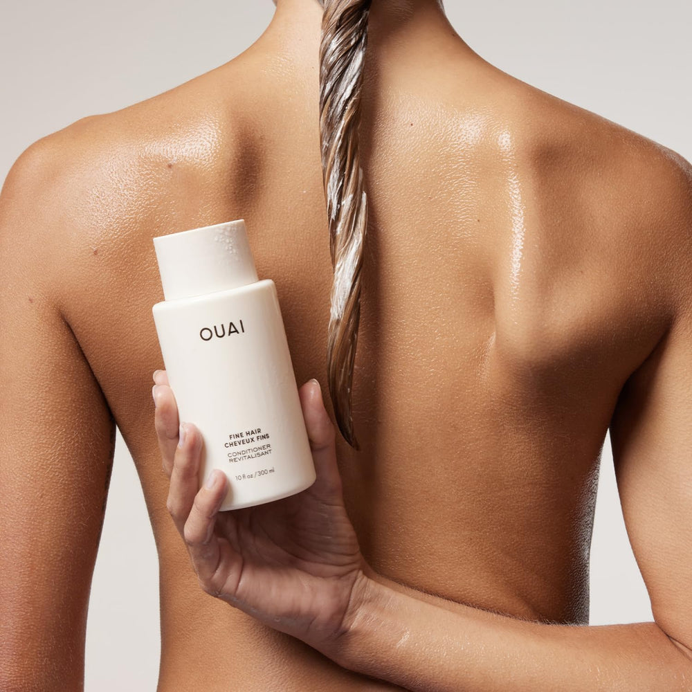 OUAI creamy conditioner texture on palm showing lightweight hydration benefit