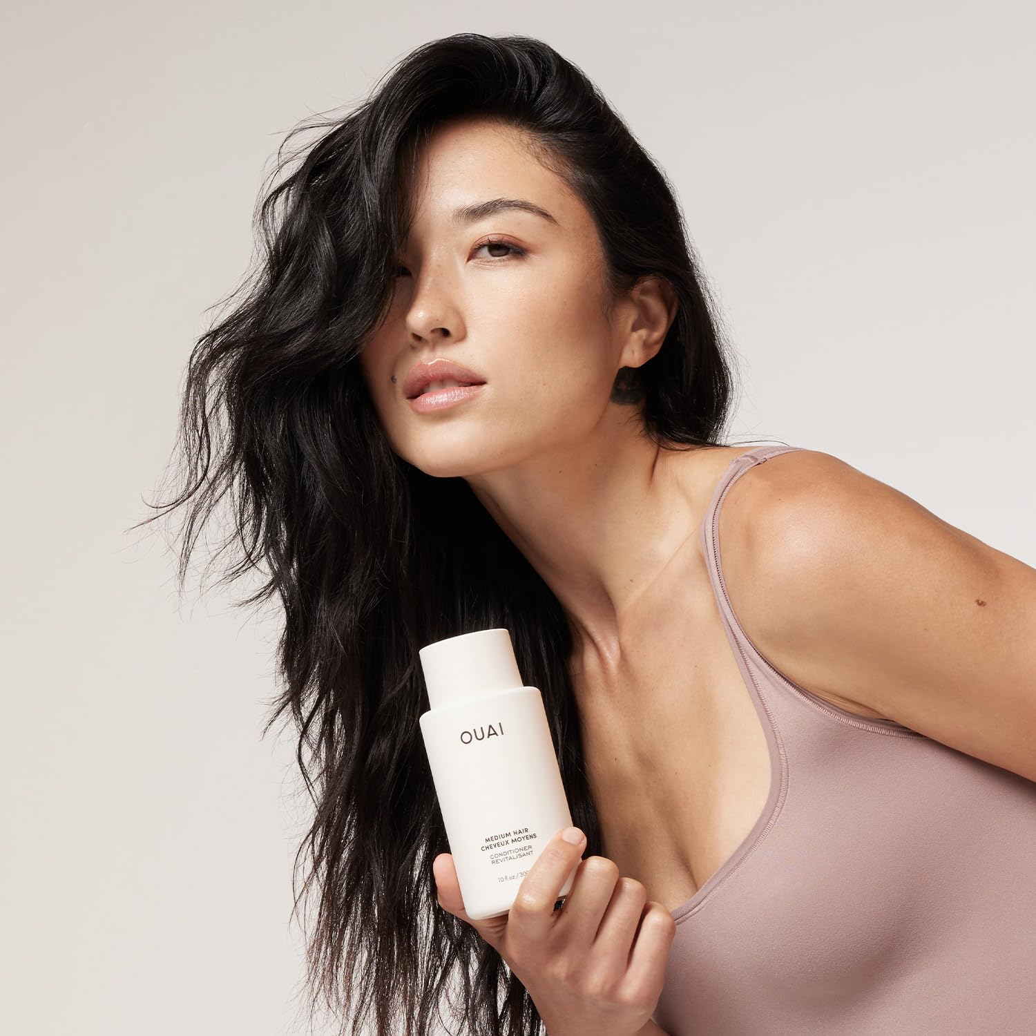 OUAI conditioner creamy texture close-up demonstrating smooth application