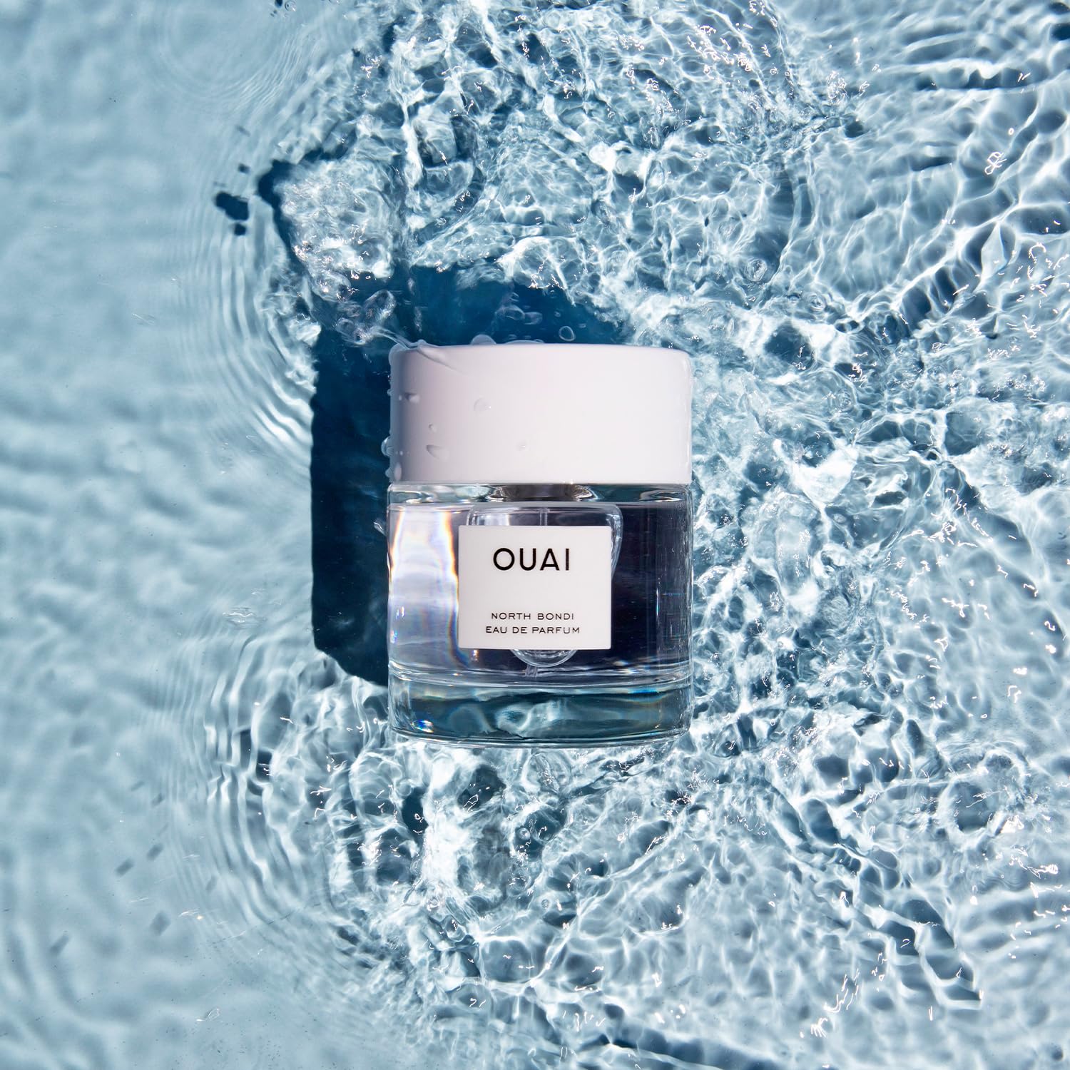 OUAI North Bondi size comparison beside a hand showing travel-friendly benefit