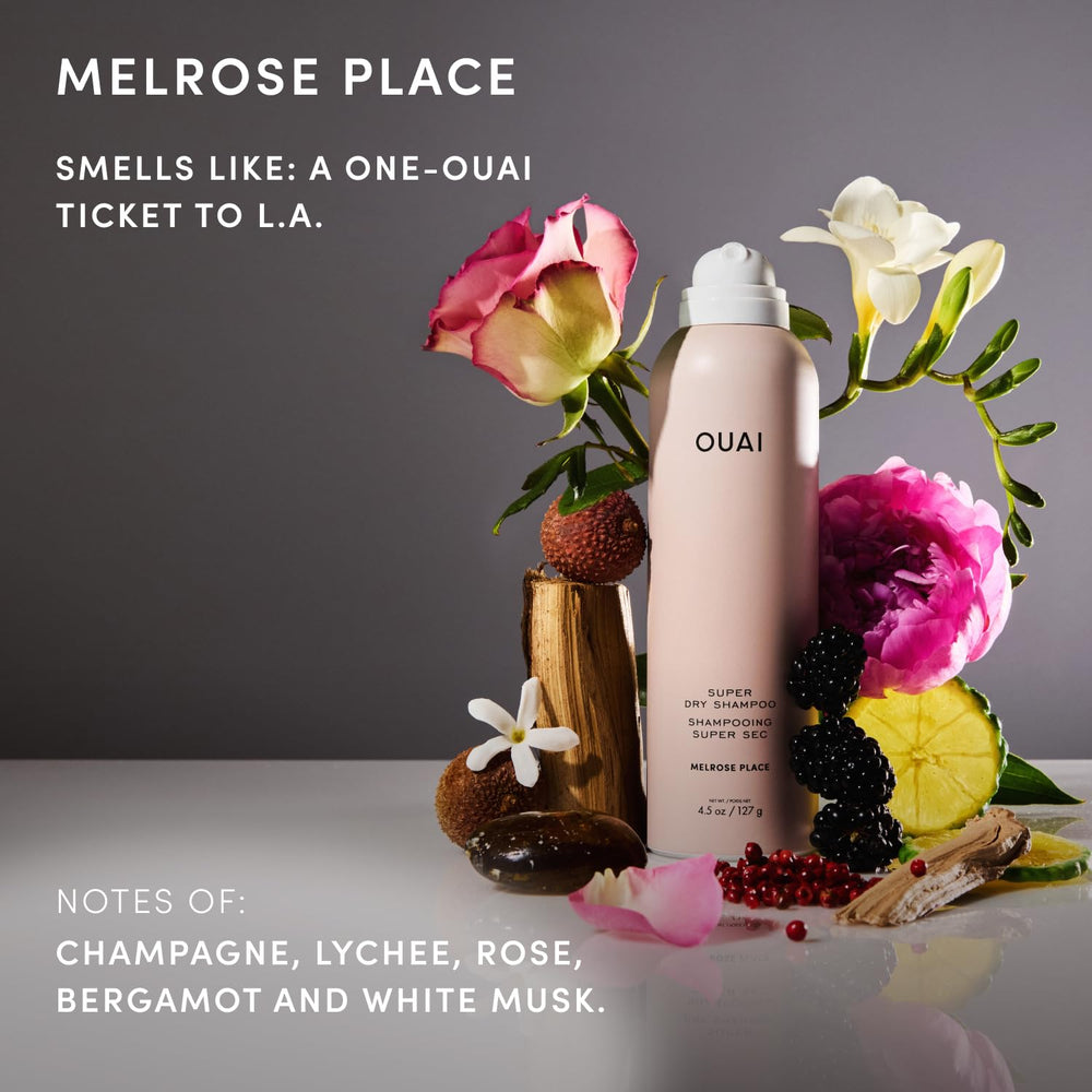 OUAI travel dry shampoo next to passport for carry-on convenience