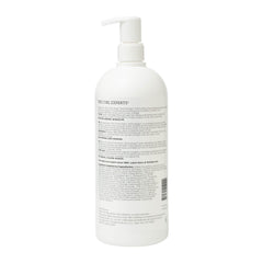 Ouidad pump and label close-up, readable ingredients and easy dispensing benefit