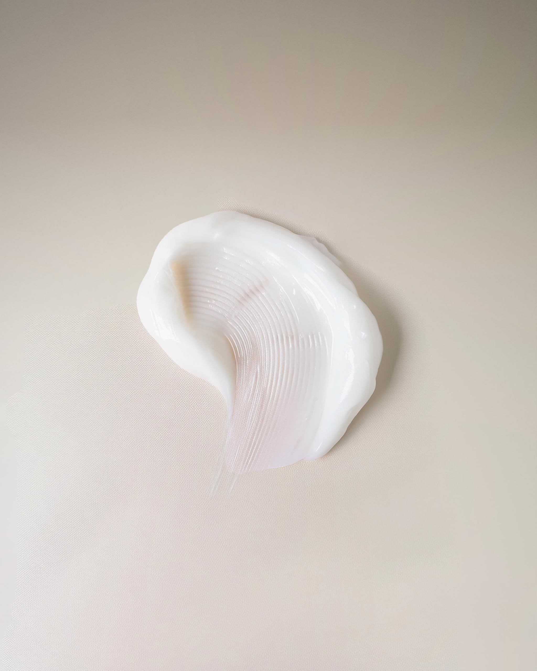 Ouidad cream texture close-up demonstrating lightweight consistency for quick absorption