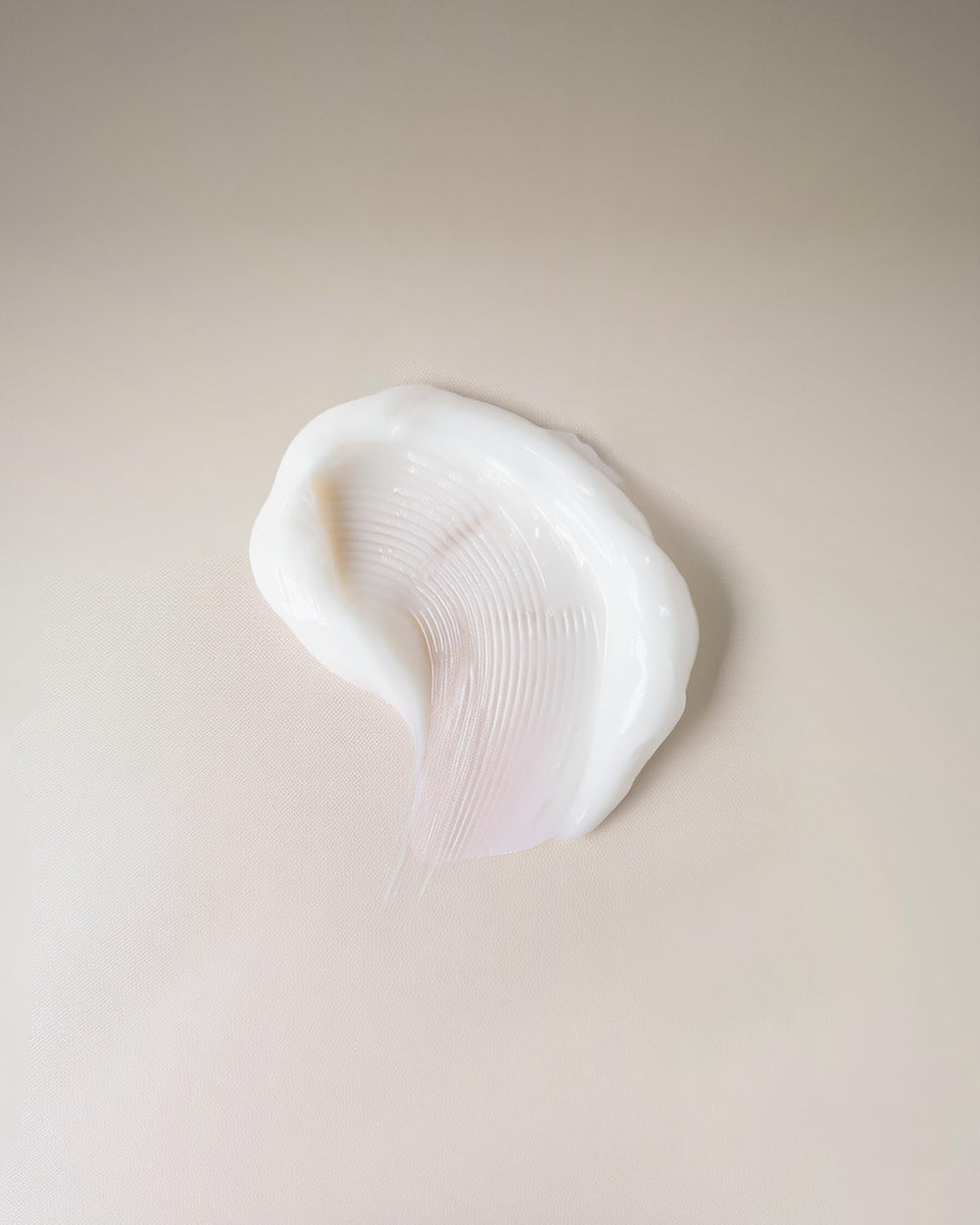 Ouidad cream texture close-up demonstrating lightweight consistency for quick absorption