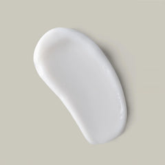 Applying Ouidad curl butter in hand to demonstrate smooth dispersion benefit