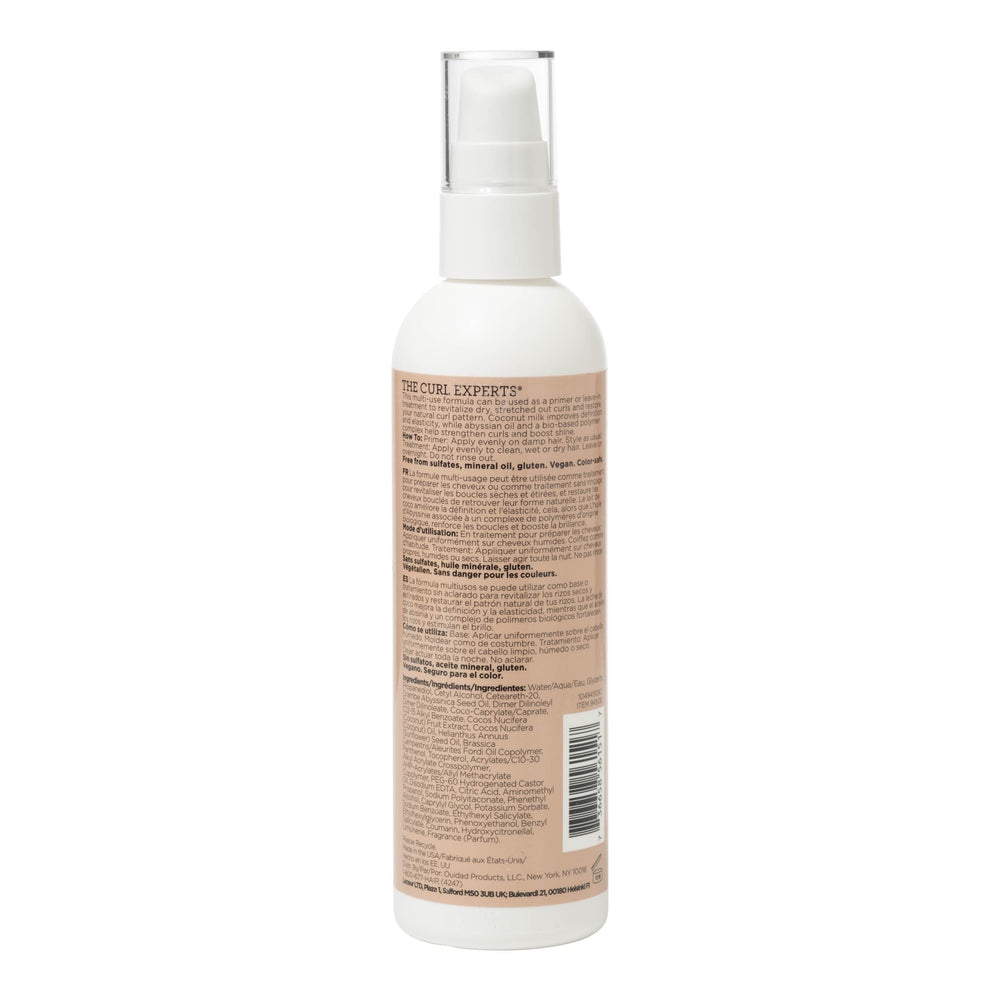 Person applying Ouidad Curl Shaper to damp curls for smoother styling
