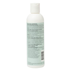 Ouidad conditioner creamy texture close-up showing lightweight, moisturizing consistency