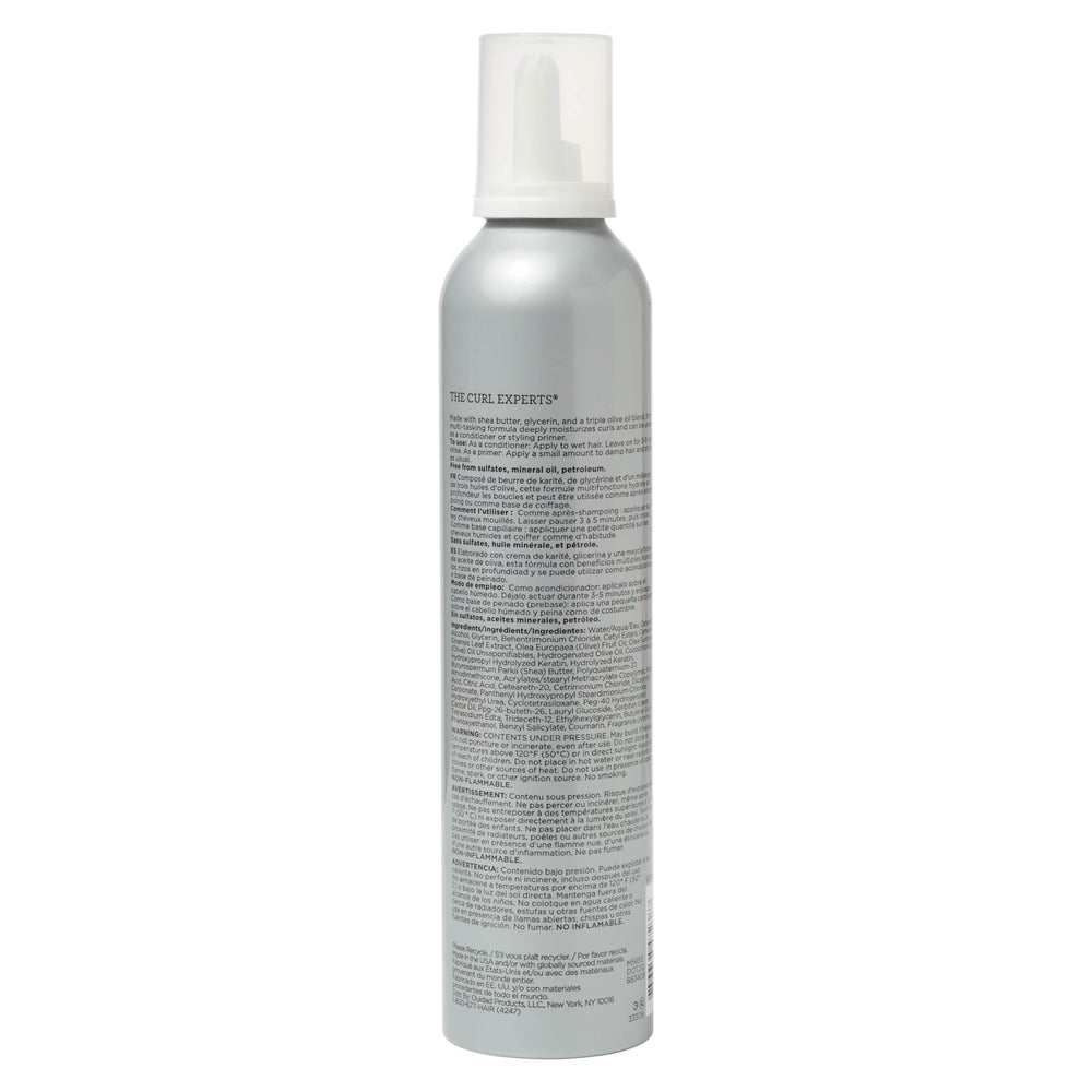 Close-up whipped cream texture of Ouidad showing rich moisture and easy spreadability