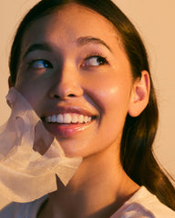 Pacifica mask held in hand to show scale and single-use convenience