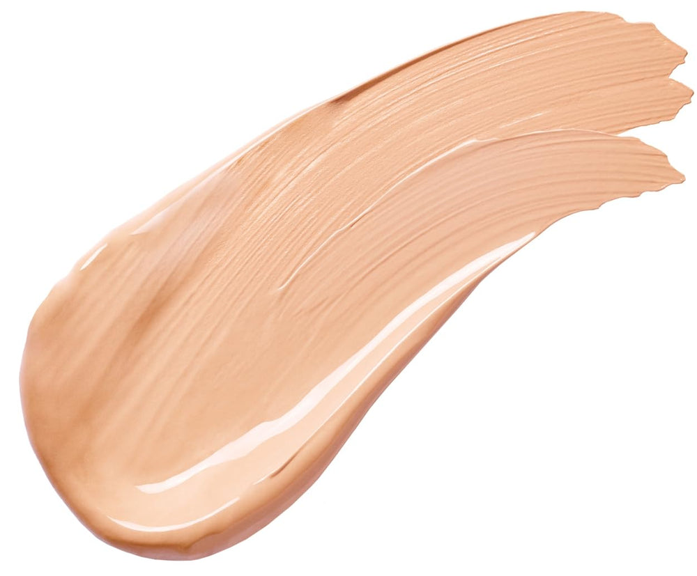 Pacifica concealer bottle beside a coin for scale showing travel-friendly size