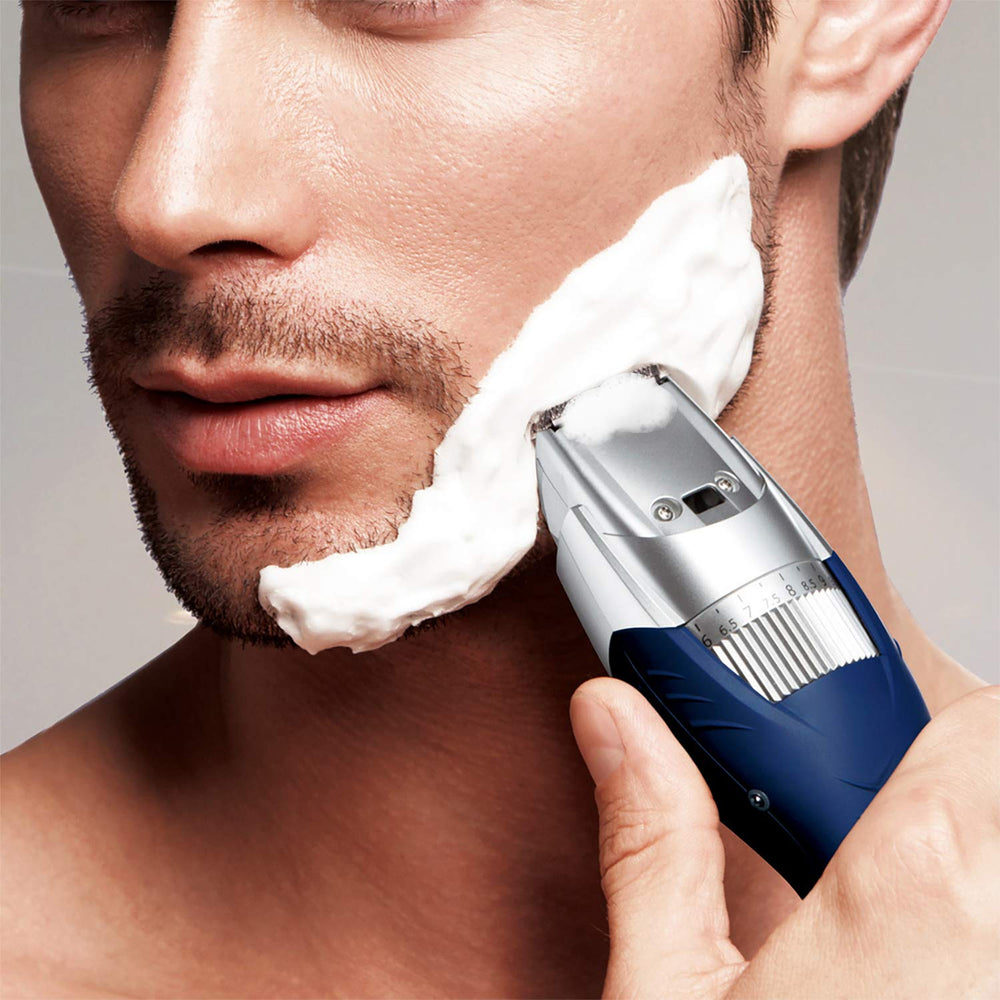 Panasonic ER-GB40-S with accessories displayed: cleaning brush and charging stand included