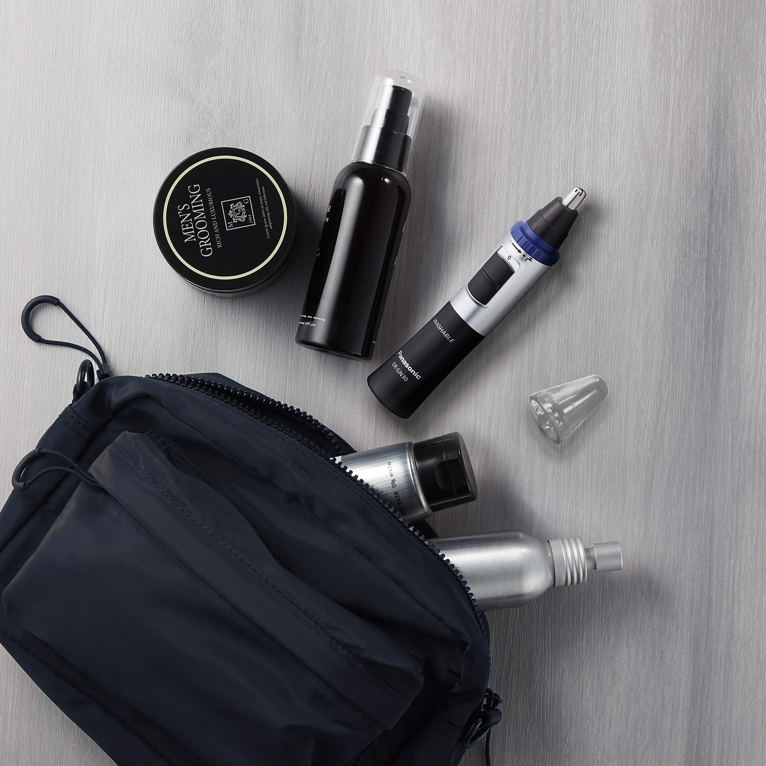 Panasonic ER-GN30-K accessories laid out including cap and cleaning brush for maintenance