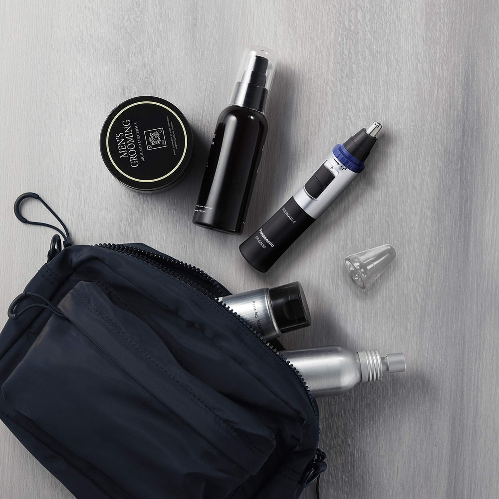 Panasonic ER-GN30-K accessories laid out including cap and cleaning brush for maintenance