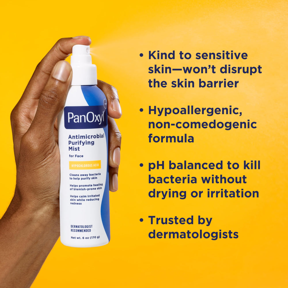 Person applying PanOxyl mist to face in bathroom showing quick soothing and refresh benefit