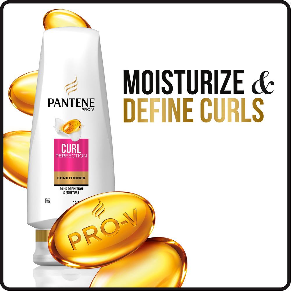Applying Pantene conditioner to wet curls for smoother detangling