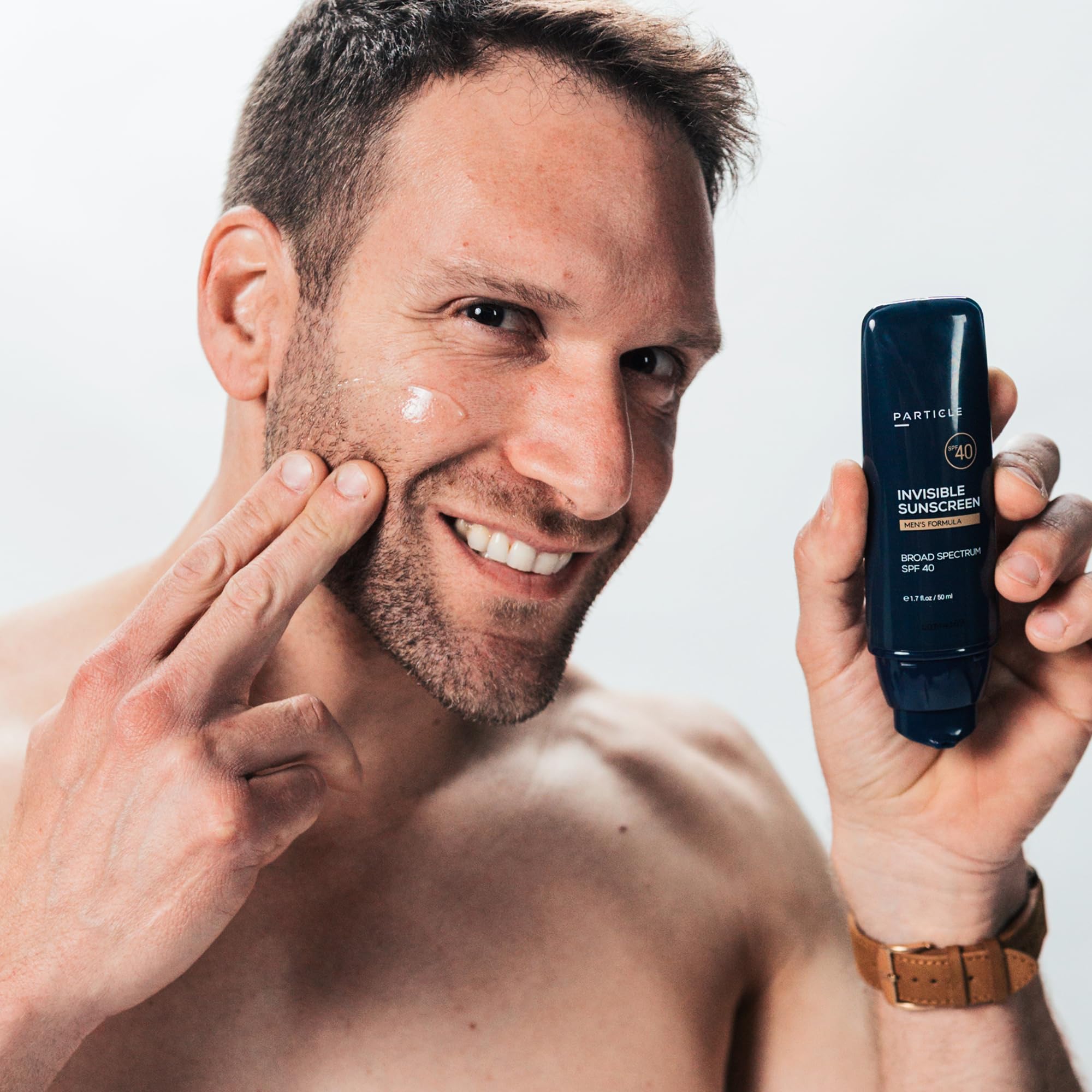 Particle sunscreen brushed through beard highlighting non-greasy, beard-friendly benefit