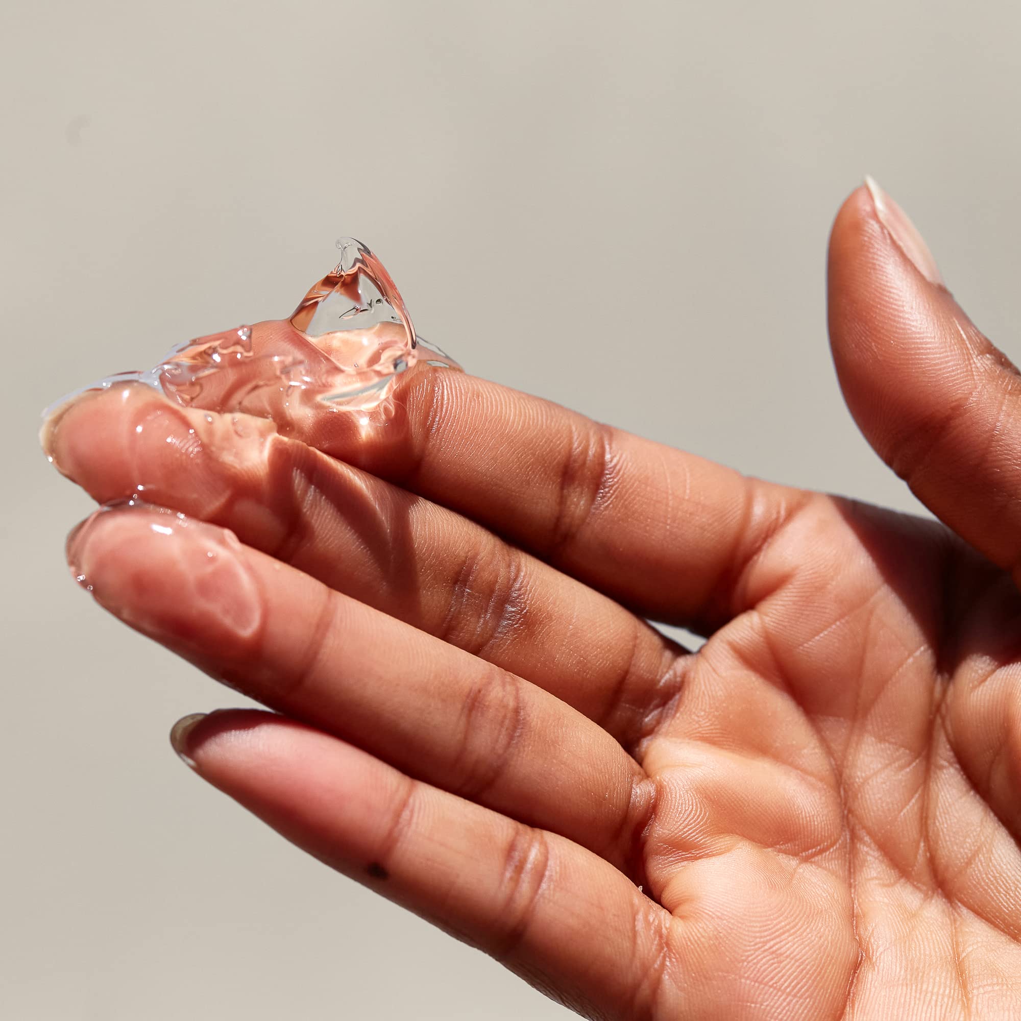 PATTERN gel in palm ready to apply, demonstrating controlled amount and quick absorption